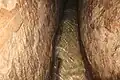 Water running the length of the conduit, carved through meleke limestone