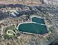 The park offers multiple facilities to its visitors, including a swimming pool (top left) and a picnic area (bottom left).