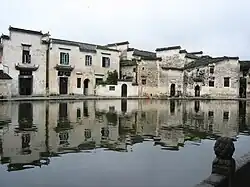 A row of residential buildings next to a body of water