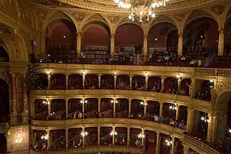 interior of ornate, traditional opera house, with much gilt and velvet