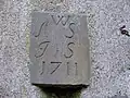 The inscription above a door. Its origin, and whether or not it relates to the house, is unknown