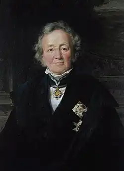 Painting of an older man with white hair dressed in a formal black garment with an ornate badge on his chest