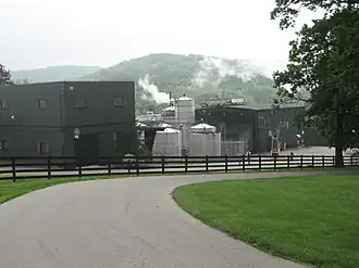 A color photograph of a building, a distillery