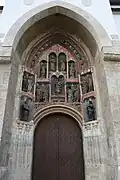 Close-up of the portal with Gothic wooden sculptures