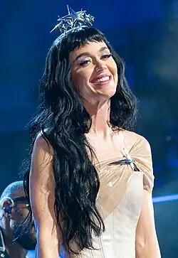 Perry smiling and wearing a crown with stars