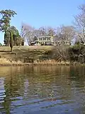 King of All Places manor house as seen from Cypress Creek