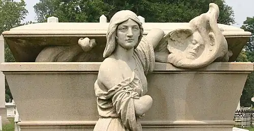 Sculpture on William Warner memorial by Alexander Milne Calder depicting a woman releasing a soul from a sarcophagus[19]