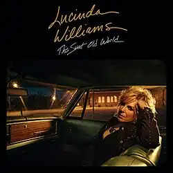 A photo of Williams seated in a car, looking back toward the camera