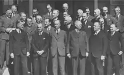 A group of men in suits pose for a picture.