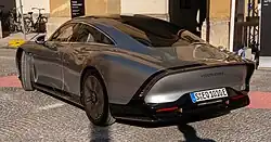 A rear three-quarters view of a silver automobile, the rear is highly tapered off at the top; a brake light bar also following the edge. The bottom of the rear is constructed wholly from carbon fibre, whilst the top is fabricated from steel.