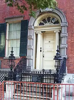 The entrance to the museum. There are Ionic columns on either side of the doorway, above which is an arch with a large, semicircular fanlight.