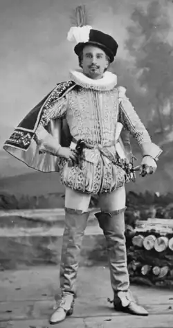 White man with neat moustache and beard in elegant Tudor costume