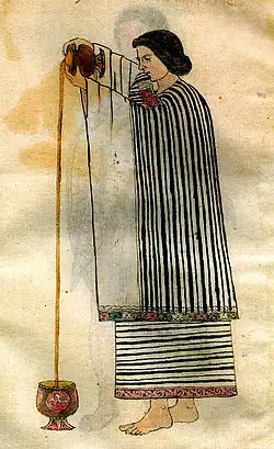 A picture of a woman pouring a liquid from a vessel at a height into another on the floor