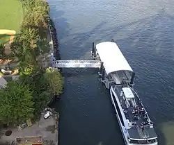 A ferry loading and unloading passengers at a dock