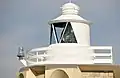 Close-up, showing the lantern and lens (centre) and emergency battery light mounted on the gallery (left).