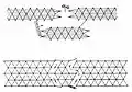 A complex obstacle belt of low wire entanglement backed by a double apron fence. Both obstacles have movable openings that can be blocked with knife rests.