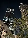 A skyward view of the Mori JP Tower and the Azabudai Hills Residence A Tower at night