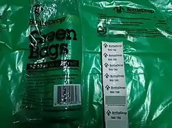 Green bag and bag tags printed from the kiosk for use with drop off service.