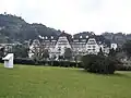 Wide view of Palácio Quitandinha, surrounded by gardens.