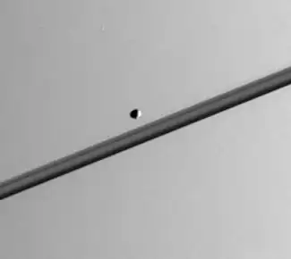 Pandora as seen from the Cassini probe in 2005; the rings of Saturn are in the background.