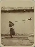 man playing a karnay trumpet