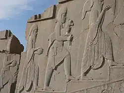 Part of the reliefs on the southern stairway of Tachara palace depicting a line of servants bearing animals, food and drinks.