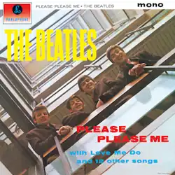 A photo of the Beatles – Ringo, Paul, George, and John – looking down over a stairwell railing