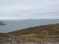 Green Island(s) from Saint Pierre island (France). Iceberg and Newfoundland in background.