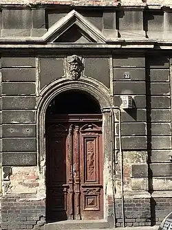 The gate and the overlooking figure