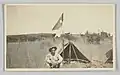 Wilber Rogan smoking a pipe at camp in the Philippines
