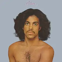 An image of Prince without any clothing looking towards the camera.