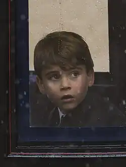 Louis, aged six, looking out of a carriage window