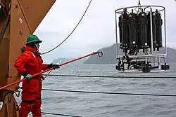 A teacher retrieves a CTD-rosette from the waters of the Bering Strait on the ICESCAPE mission in June 2011.