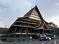Rumah Lancang or Rumah Lontik with a curved roof and boat-like structure. A Riau Malay traditional house, this is the Riau Pavilion Taman Mini Indonesia theme park.