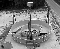 A NASA engineer takes a walk in simulated zero gravity around a mock-up of a full-scale, 7.3&nbsp;m (24&nbsp;ft) diameter space station in 1964.