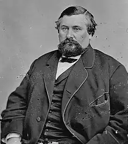 Upper-body portrait of a man in a suit.