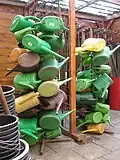 Watering cans on a stake in a school garden, Schooltuin Plutodreef Utrecht, the Netherlands