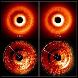 Shadow moving counterclockwise around a gas and dust disc.[26]