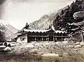 Wilson Cottage bungalow in Harsil, c. 1860. Wilson is seated to the left with his brother-in-law Mungetu Chand.