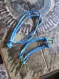 Two with diamond knot head, and buried eye with opening string, one with ends-buried-button-knot and eye adjustable by crossing sides.