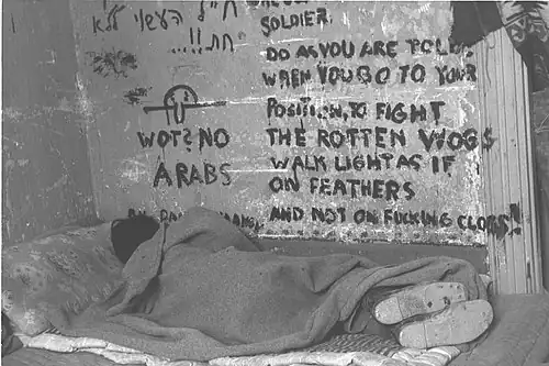 Israeli soldier sleeping during the 1948 Arab–Israeli War, Chad is seen on the wall together with inscription "Wot? No Arabs", November 1948.