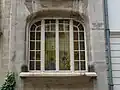 Stained glass window and signature of the architect