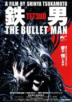 A man's head and arm is covered in a large grotesque metallic mass.