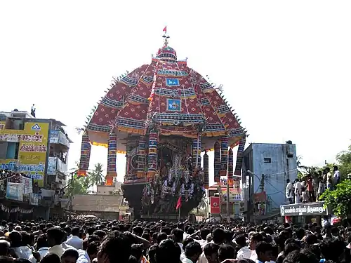 a temple car drawn by a lot of people