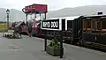The Ffestiniog engines Palmerston and Prince arriving tender first at rainy Rhyd Ddu with vintage coaching stock.