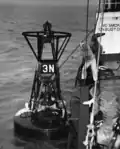 Lilac crew knocks ice off buoy