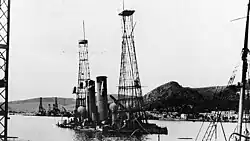 Photograph showing both ships partially underwater, the cage mast sticking out of the water