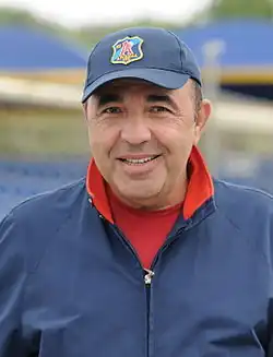 Rabinovich outdoors, in an open-necked shirt
