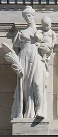 Marble statue of a woman holding grain and a baby