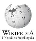 Wikipedia logo displaying the name "Wikipedia" and its slogan: "The Free Encyclopedia" below it, in Chamorro